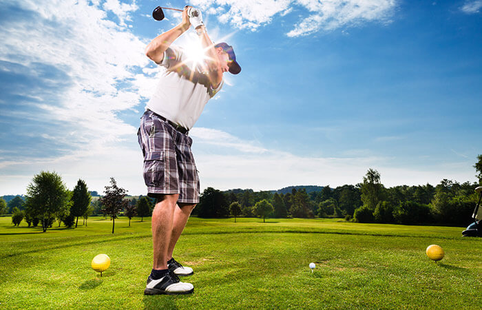 Man golfing in Maine