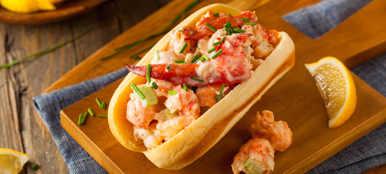Lobster roll on a wooden plate